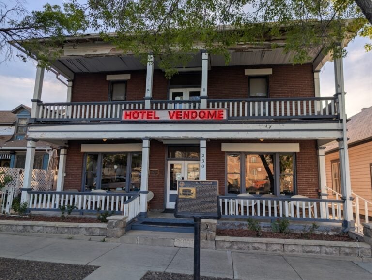 Historic Hotel Vendome with its red neon sign and two-story porch on Cortez Street in Prescott, Arizona