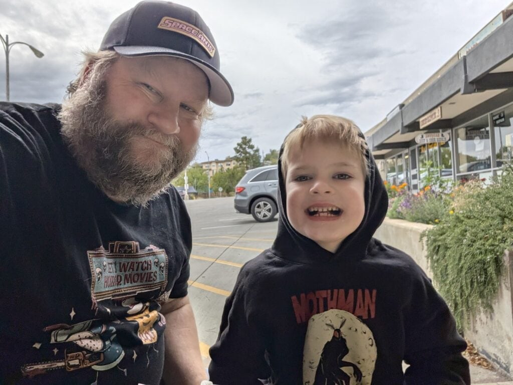 Chad of Prescott Insider and his youngest son smiling outside Outlaw Donuts on West Goodwin Street in Prescott, Arizona