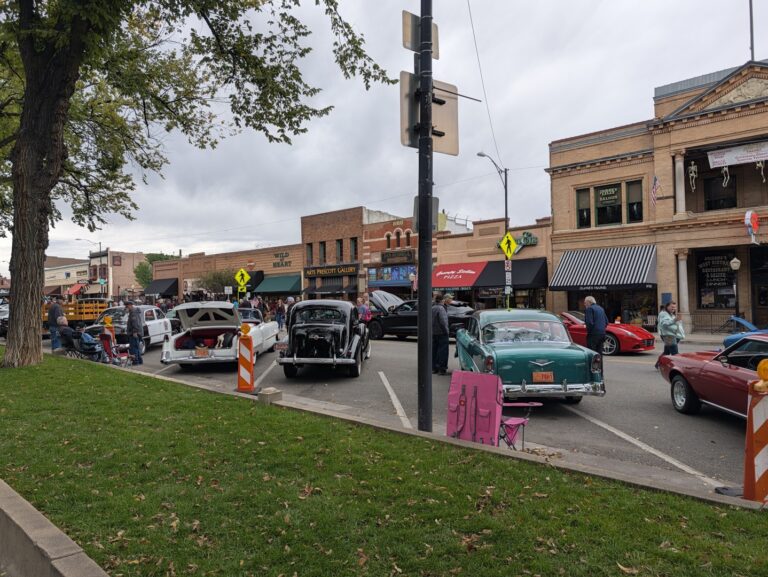 Classic cars and spectators on a downtown street beside the Courthouse Plaza during a car show in Prescott, Arizona