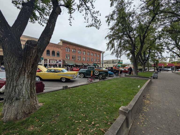 Classic cars parked along Whiskey Row in front of Matt's Saloon during a car show, seen from the Courthouse Plaza in Prescott, Arizona