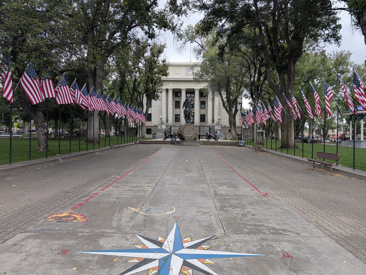 Flag-lined walkway across the Courthouse Plaza to the Bucky O'Neill Rough Rider monument and the Yavapai County Courthouse in Prescott, Arizona
