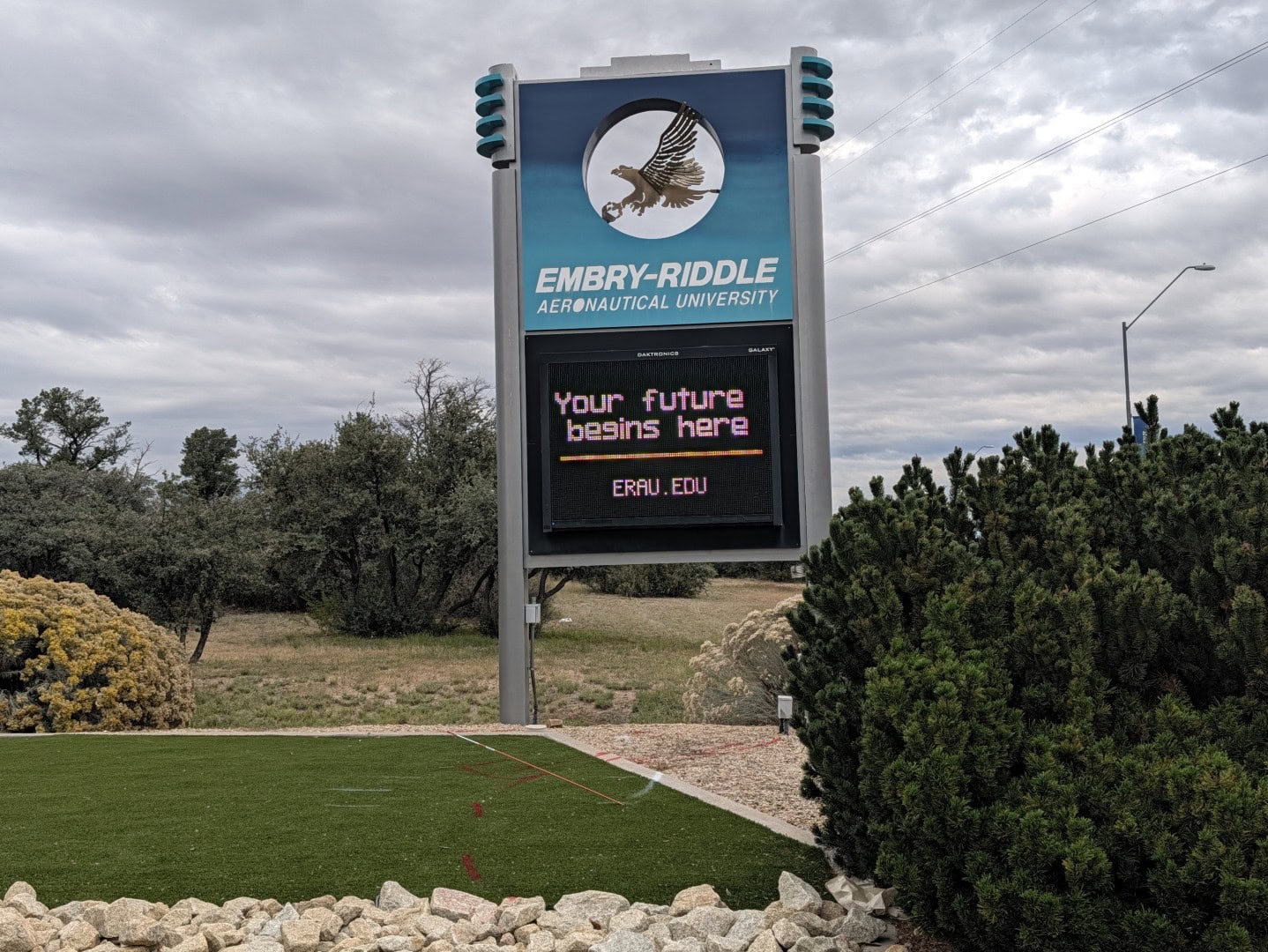 Embry-Riddle Aeronautical University entrance sign with its eagle logo and a digital message board on the Prescott, Arizona campus